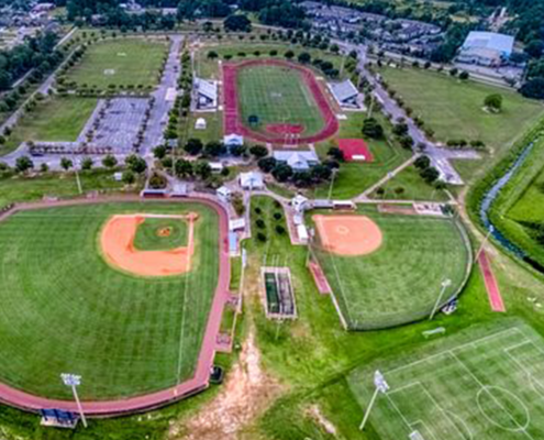 gulf shores sportsplex pickleball facility pickleball racket sports alabama tourism wiffle ball court net softball baseball dugout tournament championship track and field running jumping football lacrosse soccer field goal yard lines touchdown multiplex facility