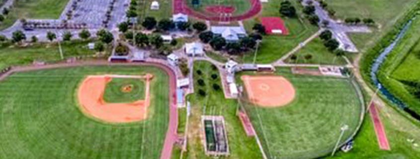 gulf shores sportsplex pickleball facility pickleball racket sports alabama tourism wiffle ball court net softball baseball dugout tournament championship track and field running jumping football lacrosse soccer field goal yard lines touchdown multiplex facility