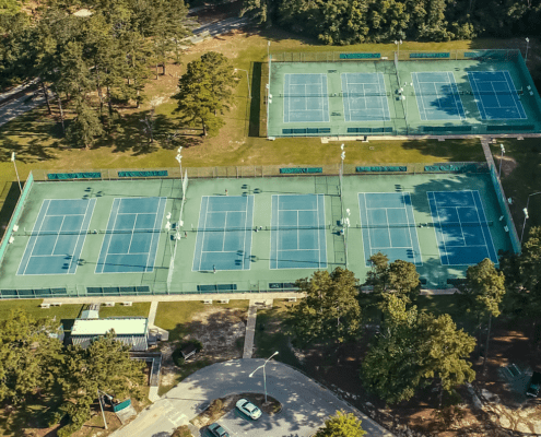 Medal of Honor Park tennis soccer softball baseball gymnastics disc golf sports alabama mobile court match set score racket paddle goal goalie net field grass sidelines diamond field diamond dugout double header tournament championship routine tumbling bar course par flip entertainment spectators seating concessions